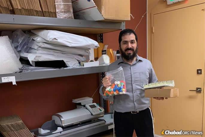 Rabbi Elie Estrin, an Air Force Reserves Chaplain and Military Personnel Liaison for the Aleph Institute helps pack Chanukah packages for worldwide distribution. He is leading the Chanukah programs at Patrick Air Force Base and the U.S. Southern Command in Florida.