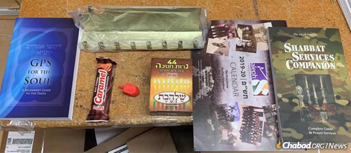 Boxes sent by Aleph Institute to U.S. military personnel around the world are filled with all things Chanukah, including menorahs, boxes of candles, dreidels, chocolate bars, Jewish calendars and books.