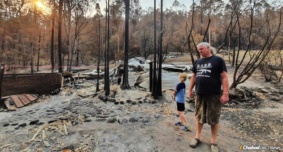 Verne Dove&#39;s huband, Troy, and her son, Jaidal, survey the destruction of their home in tiny Nana Glen (population 1,055) in New South Wales’s tropical north.