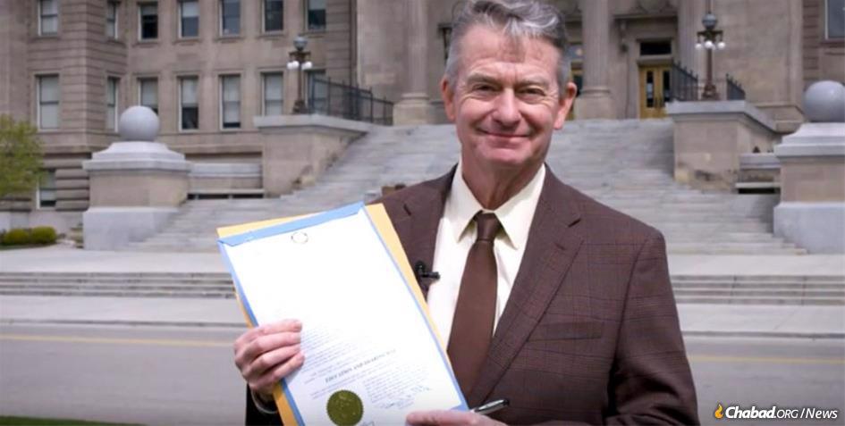 Idaho's Gov. Brad Little reads his state's “Education and Sharing Day” proclamation in front of the State Capitol building.