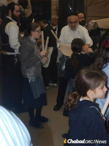 Rabbi Levy with family members at an annual matzah baking.