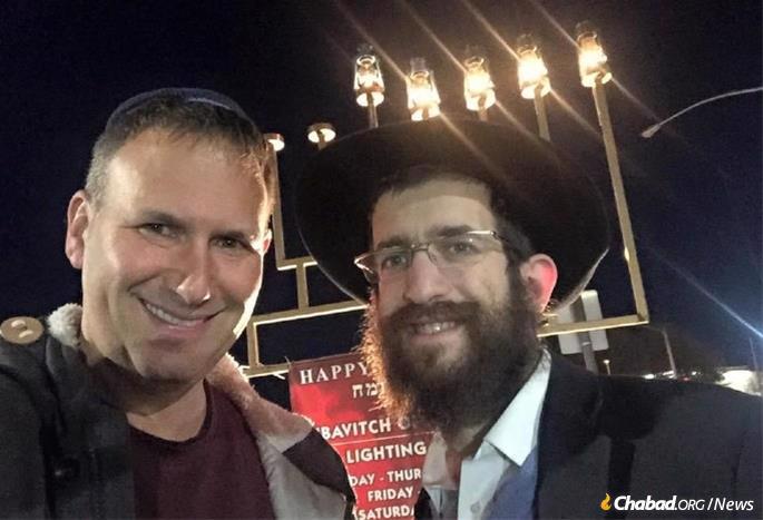 Seth Feldman, left, has developed an active and committed Jewish life. Here, he cebrated Chanukah with Rabbi Yosef Kramer of Chabad of Little Rock, Ark.
