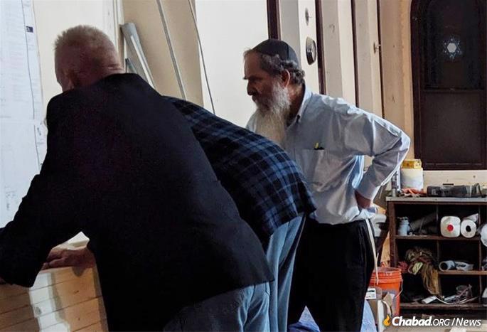 Rabbi Menachem Schmidt goes over contruction plans with the architect and builder.