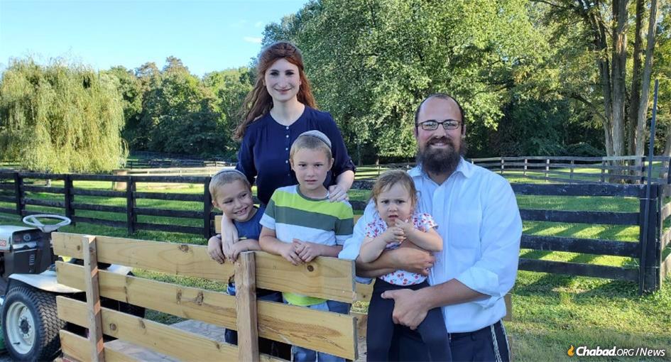 Rabbi Zalman and Goldy Sandhaus with their children and their tractor at Pardess Chabad Farm in New York's Hudson Valley.