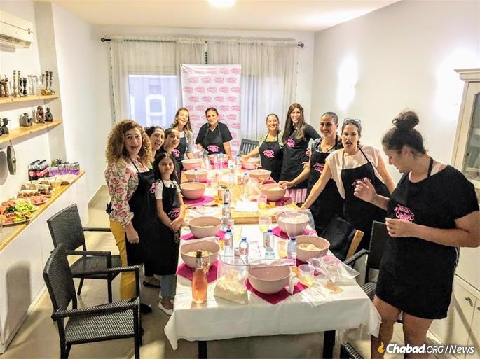 Jewish women gather for a challah bake.