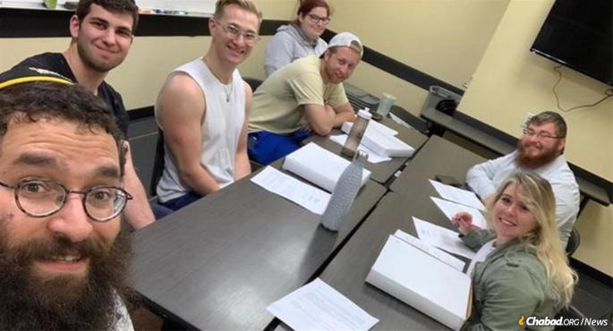 Students at the University of Central Florida with Rabbi Chaim Lipskier, left, take part in the weekly study of the Rebbe&#39;s Likkutei Sichot, part of a worldwide effort to study the entire 39 volumes over eight years.