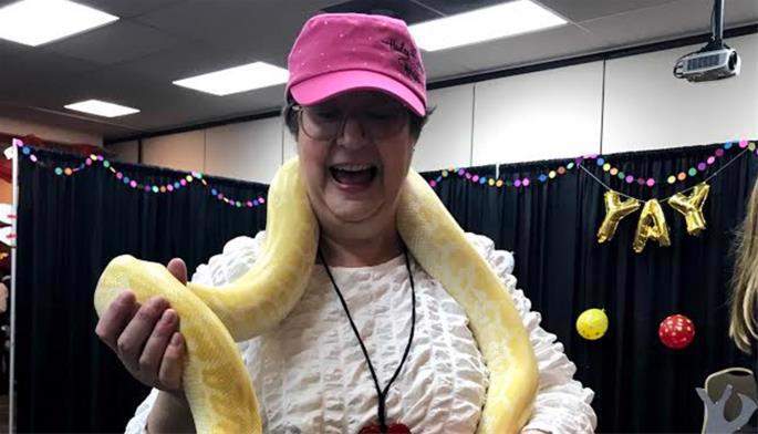 Karen with the boa constrictor at her local Chabad Purim party, March 2020.