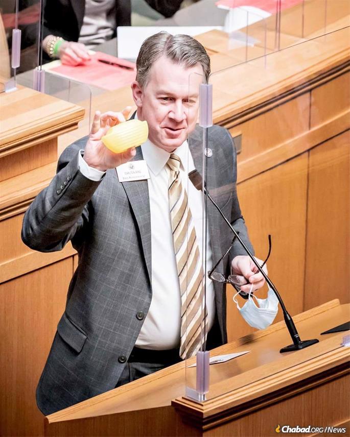 Rep. Carlton Wing holds up a charity box, known as an ARK, in the Arkansas House of Representatives