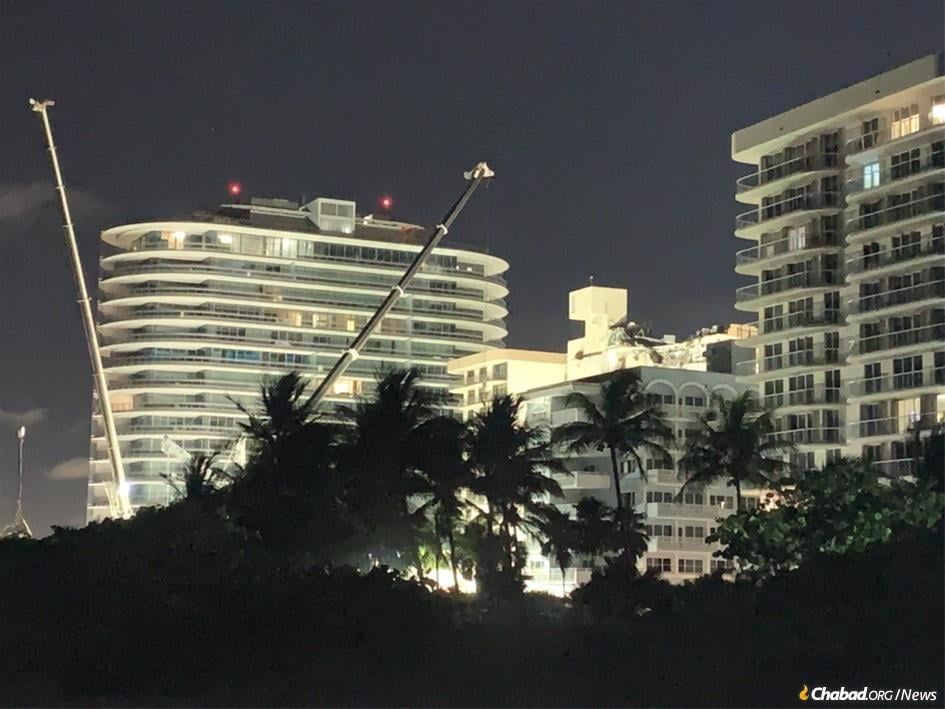 The search-and-rescue site at where Champlain Towers South once stood in Surfside, Fla., is illuminated as work goes on day and night.