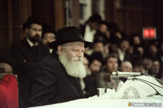 The Rebbe left the makeshift hospital at 770 on Rosh Chodesh Kislev, seen here leading a farbrengen gathering on Chanukah, later that month. (Photo: Yossi Melamed/Jewish Educational Media)