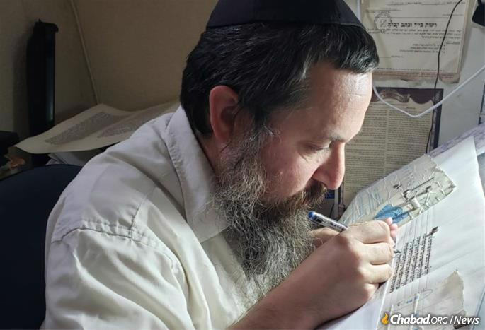Scribe Rabbi Mordechai Ross toils over a Torah scroll he is writing in memory of his daughter, Sima.