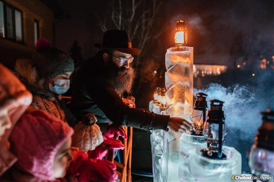 Rabbi Yerachmiel Gorelick kindles the ice menorah at a Chanukah event in Tyumen, a major city in Siberia.