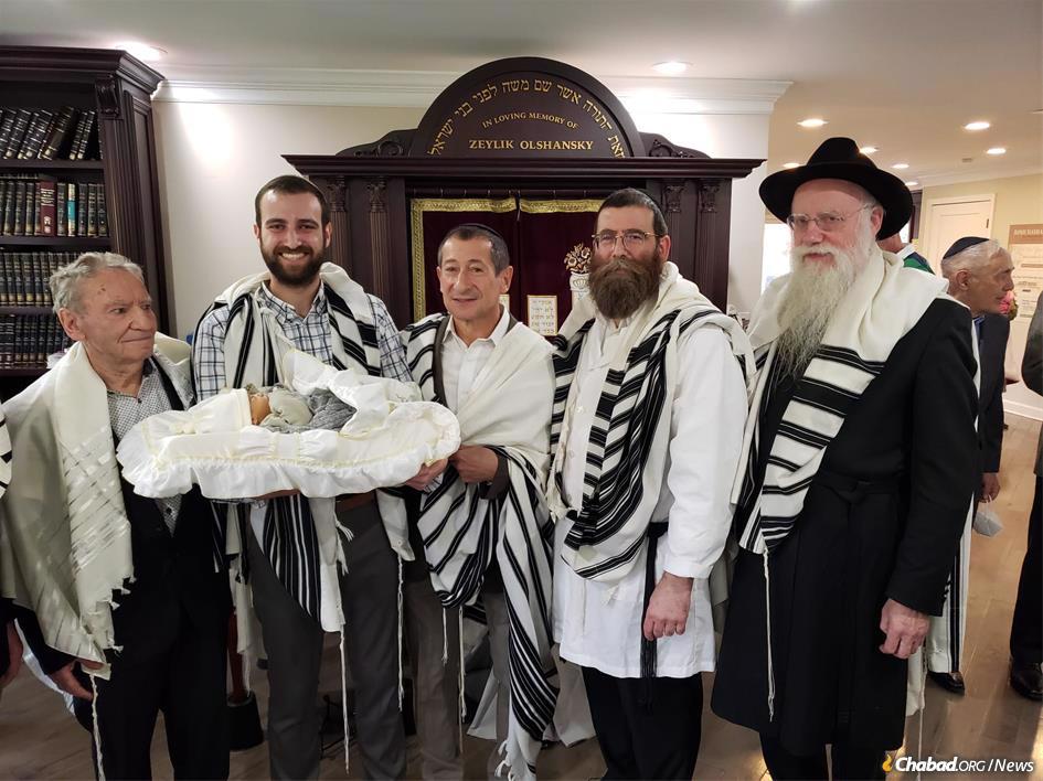 From left: Yisrael (Leonid) Kleper; Dr. Shlomo (Roman) Magid, holding his son Zeev Yitzchak; Dr. Dovber (Boris) Lelchuk; Rabbi Levi Heber; and Rabbi Shmuel Notik