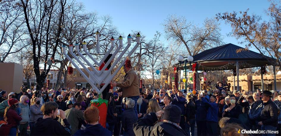 A crowd gathers in Santa Fe for an outdoor menorah-lighting.