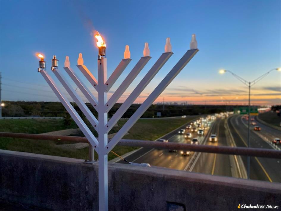 In Austin, Texas, a menorah is lit on an overpass where a month earlier a neo-Nazi group displayed a banner reading “Vax the Jews”. (Photo: Jamil Donith/Spectrum News1 Texas)