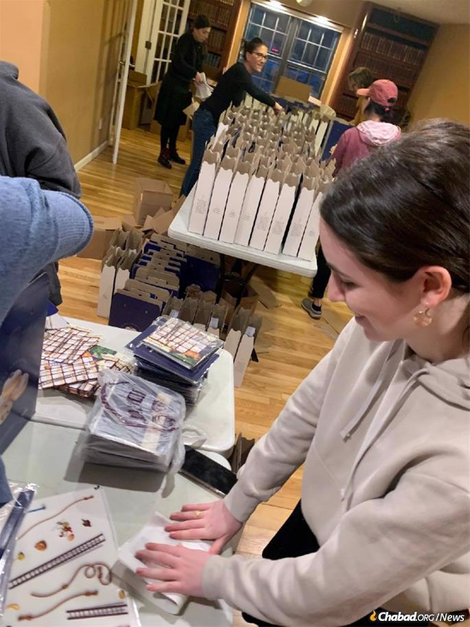 On Long Island, volunteers rush to pack menorah sets for last-minute delivery.