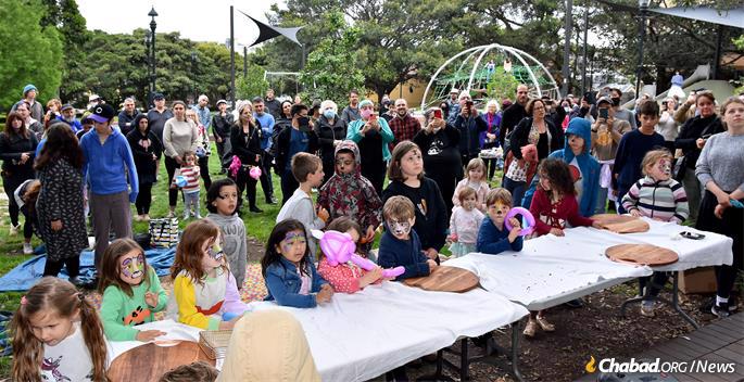 In the Newtown neighborhood of Sydney, children gather for a pre-lighting party.
