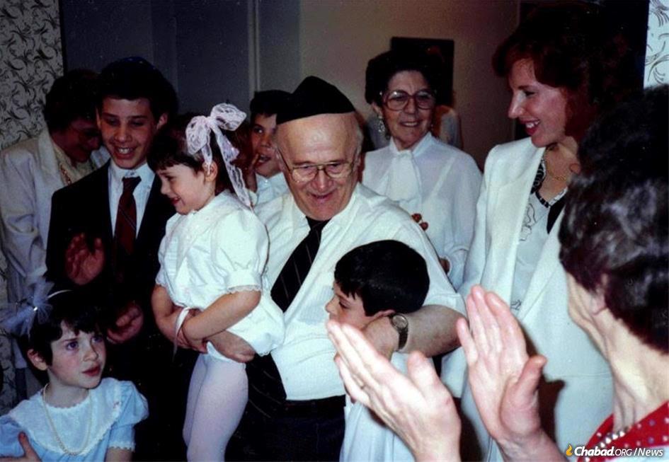 Shmuel Goldwasser holds his granddaughter, Rachele.