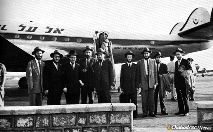 After Arab terrorists killed five students and their teacher in 1956 in the midst of prayer at a vocational school in Kfar Chabad, Israel, the Rebbe dispatched 12 yeshivah students (nine of the 12 seen here) to Israel to help lift the nation's spirits. The Rebbe’s representatives arrived in the Lod airport on July 13, 1956, remaining in Israel for 28 days. From left: Rabbis Zushe Posner, Sholom Ber Butman, Sholom Ber Shemtov, Dovid Schochet, Yosef Rosenfeld, Sholom Eidelman, Faivel Rimler, Shlomo Kirsh and Yehuda Krinsky. (Photo courtesy of Kehot Publication Society)