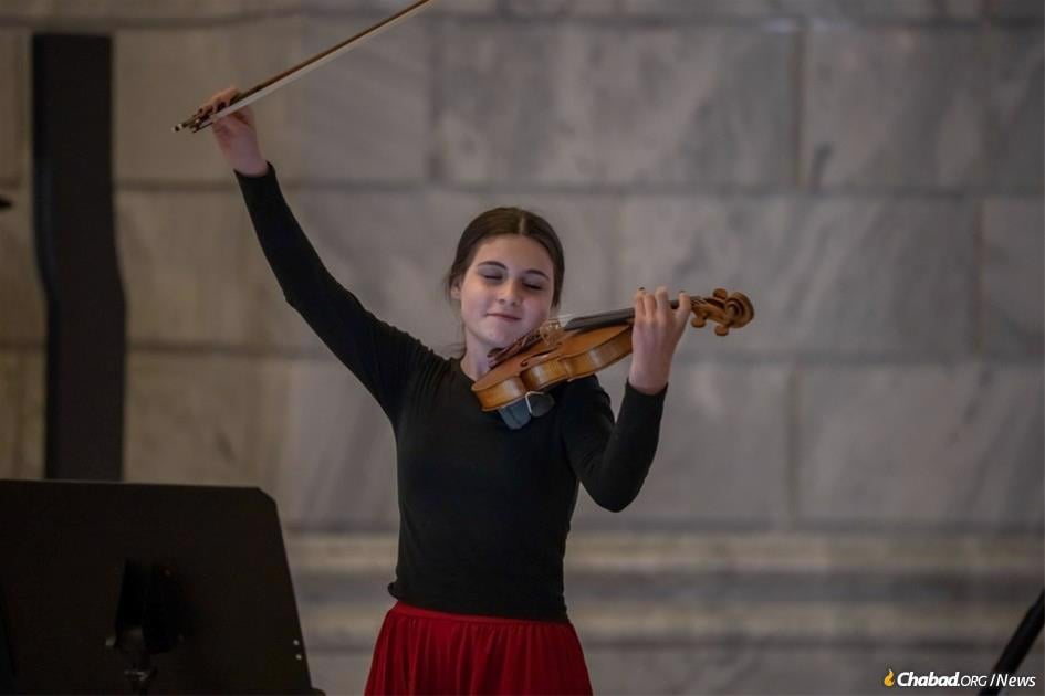 Nesya Fertel, 13, playing at Chabad's menorah lighting celebration at the Utah State Capitol.