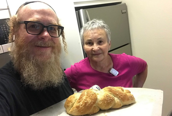 Pinchas baking challah with his mother.