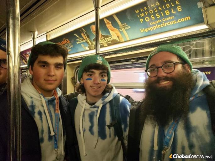 Heading back by subway to the Crown Heights section of Brooklyn, were from left: Walter Belenkiy, Shai Kaszynski and Rabbi Chaim Schanowitz.(Photo: Mendel Super)
