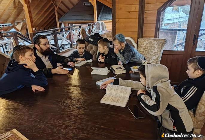 Boys use their time to study Torah with their teacher.