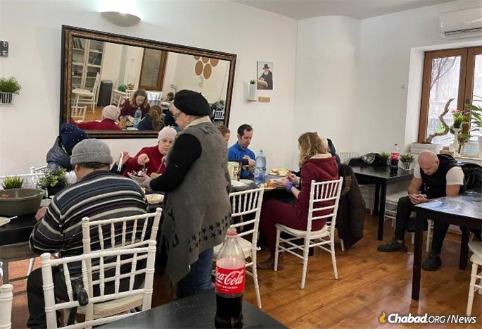 Refugees just out of Ukraine arrive at Chabad of Bucharest for a hot meal