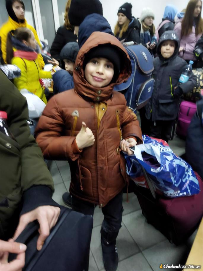 A child from Zhitomir's Alumim children's home is excited to arrive in Romania.