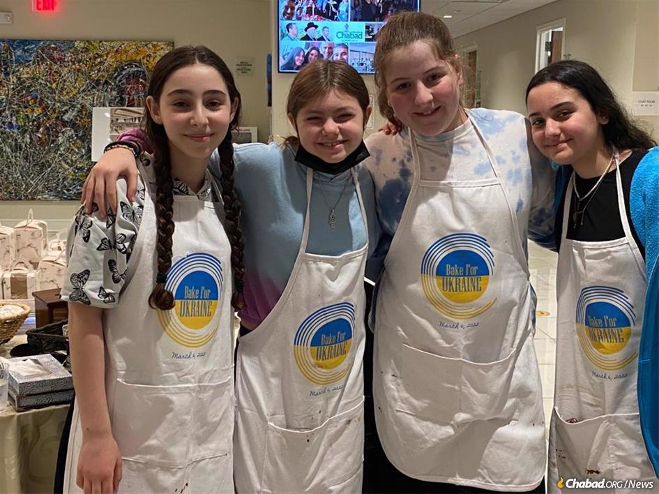13-year-old Maya Solomon, left, recruited a group of friends and hosted a bake sale that netted more than $4,000 in aid for Ukrainian children.