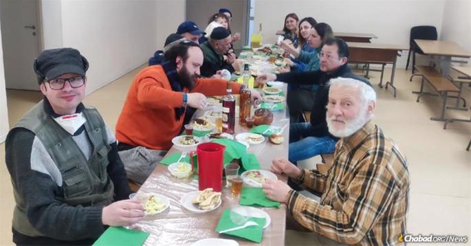 Despite ongoing attacks in Kiev on Purim day, Daniel, a young volunteer with Chabad of Kiev, put together a festive Purim meal after the Megillah reading.
