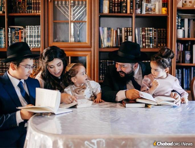 Rabbi Mendel and Esty Cohen with their children at their home, which is no longer habitable.