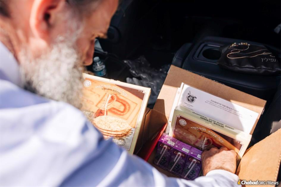 Rabbi Zvi Konikov packs a box of Passover supplies for astronaut Etyan Stibbe who will be taking off for the International Space Station tomorrow.