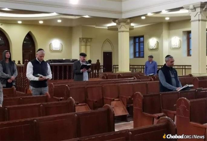 Men pray the afternoon service before Passover.