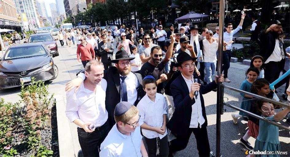 A Torah-dedication ceremony parades down the streets of downtown Chicago on its way to Chabad of River North.