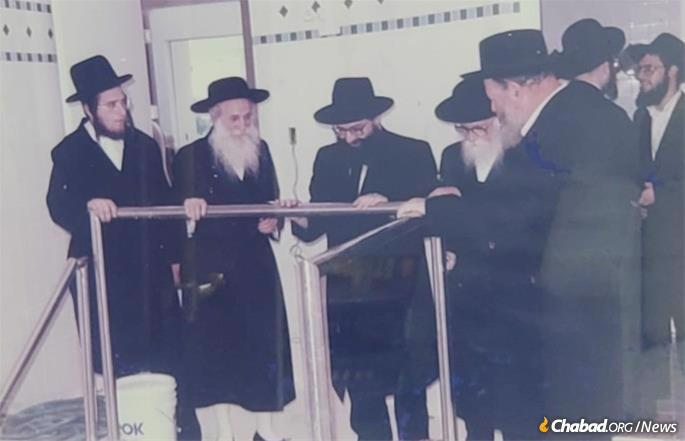 The Satmar Rebbe, Rabbi Moshe Teitelbaum; Rosh Yeshivah of Yeshivah Gedolah of Miami Beach, Rabbi Leib Schapiro; "Eiheler Rav," Rabbi Meisels; and Rabbi Weberman inspect the Miami Beach Mikvah, which was being built according to the highest specifications, including the Chabad preference for a rainwater cistern below the immersion pool.