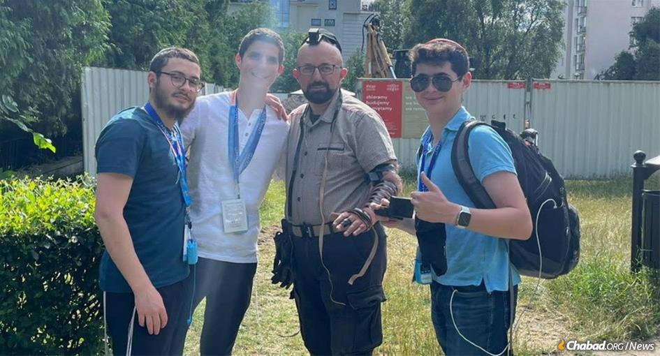 While on a CTeen trip to Poland and Israel, Atlanta high school student Yakov Vinnik, right, encouranged an archeologist from Russia who he met at Auschwitz to put on tefillin.“I am not sure what took me over at that moment, but for the first time in my life, I asked a complete stranger if he would join me in putting on tefillin,” says Viinik, who was joined by (from left) rabbinical students Mendel Backman, Levi Harlig, and the archeologist.