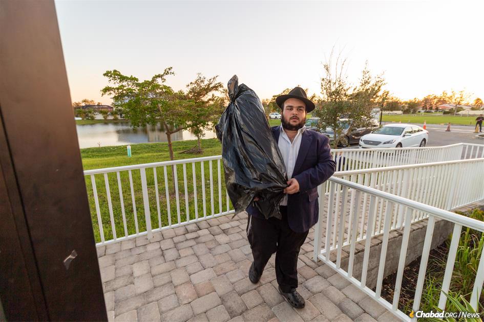 A Torah scroll taken to safety during the hurricane is returned to the synagogue. (Credit: Chabad.org/Tzemach Weg)
