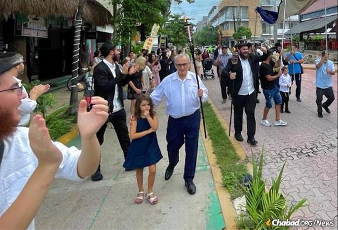  After the final letters were written, the community went out to the closed-off streets to dance and share Jewish pride. Passersby cheered the crowd on and took photos, while some Jewish tourists happened upon the parade and joined in the joyful celebration.