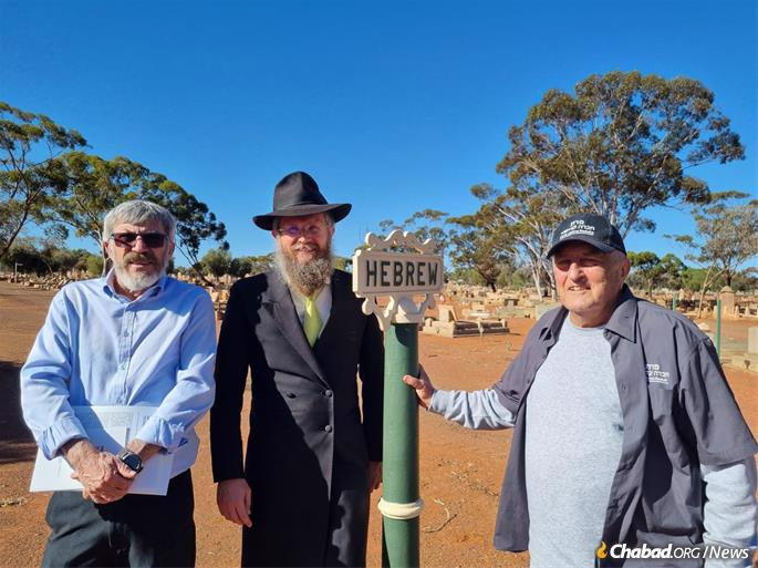The small Jewish section in Kalgoorlie’s cemetery is marked by a sign reading “Hebrew.” From left: Perth Chevra Kadisha President Mike Gomer; Rabbi Shalom White, director of Chabad of Western Australia; and Perth community member David Ninio.
