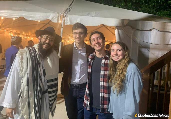 At Georgia Tech, Rabbi Shlomo Sharfstein and students gather for a communal meal to break the fast after Yom Kippur.
