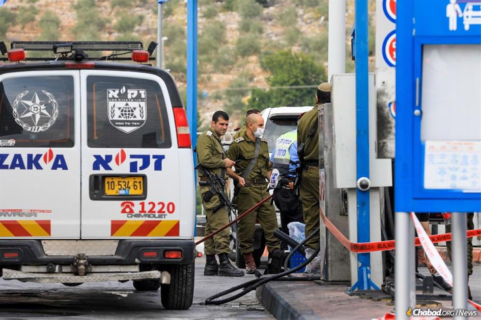Security and medical personnel gather at the scene of a terrorist stabbing at a gas station near Ariel, Israel. (Photo: Nasser Ishtayeh/Flash90)