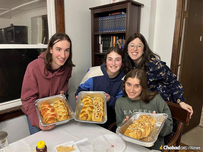 Chana Filler, right, bakes challah with students at Chabad of Ithaca College