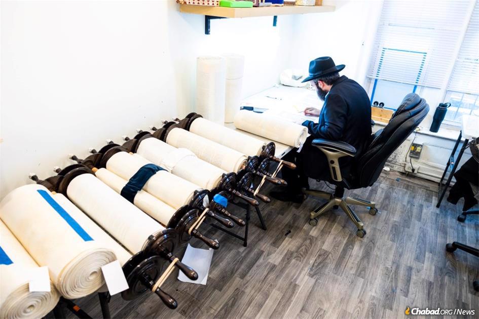 A scribe works on one of the 36 Torah scrolls that will be completed at the International Conference of Chabad-Lubavitch emissaries.