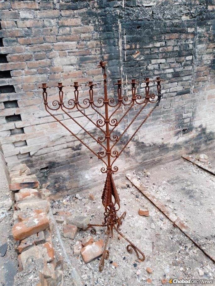 The large metal Chanukah menorah that once graced the Mariupol synagogue sanctuary somehow survived the intense fires that destroyed the building and was recovered a day before Chanukah.