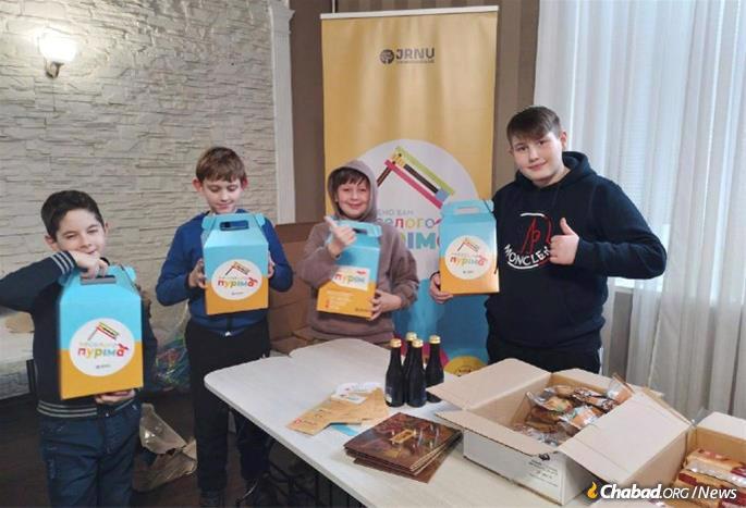 Children in Ukraine with their Purim gift packages distributed with the help of the Jewish Relief Network Ukraine.