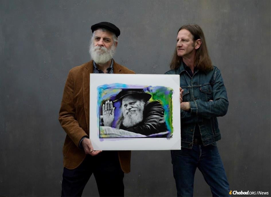 Yoel Seliger (left) and Mark Seliger will release 250 limited edition prints of this abstract mixed-media artwork featuring Mark’s original 1984 photograph of the Rebbe with Yoel’s digital painting superimposed that are being sold to benefit the Jews of Ukraine.
