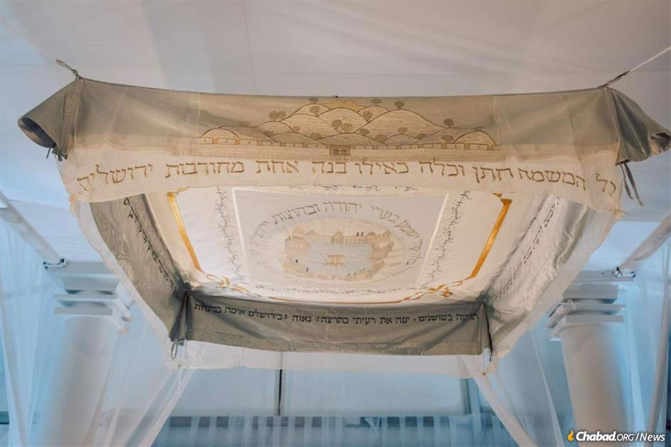 A chuppah (bridal canopy) sewn from the wedding dress of Nava Applebaum, a young bride-to-be who was murdered 20 years ago in a terrorist attack the night before her wedding.