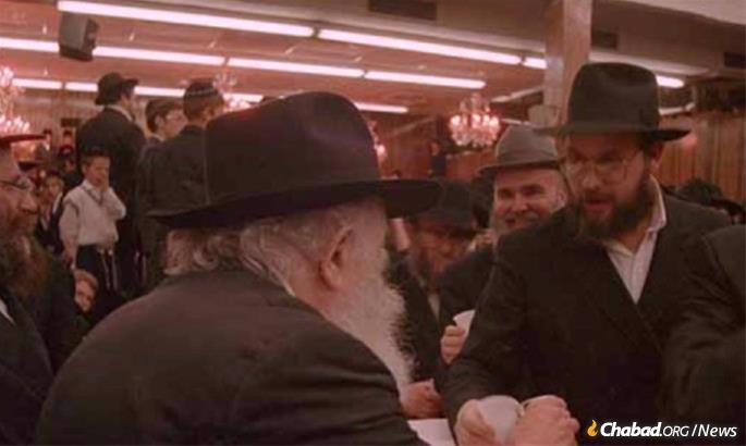 Goldstein receives “kos shel brachah”—wine the Rebbe would hand out after a holiday.