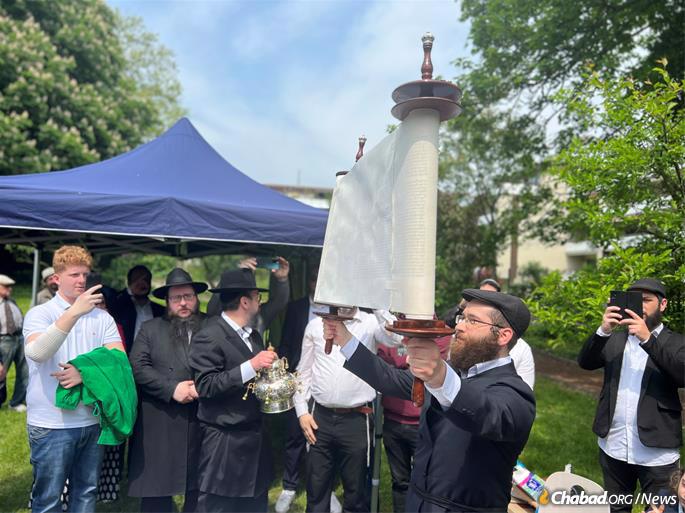 Raising the Torah after its completion.